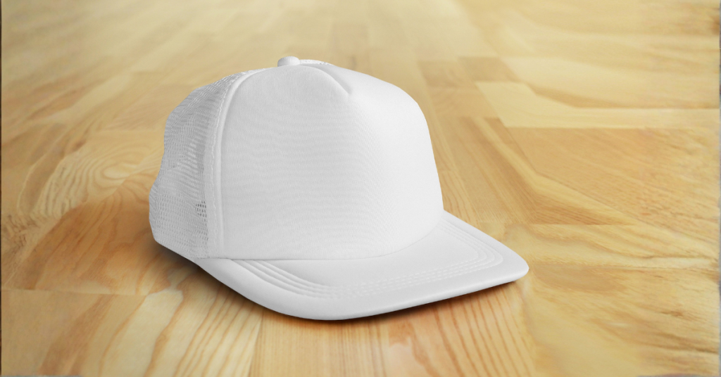 White custom baseball cap with mesh back on wooden surface - promotional headwear for brand recognition